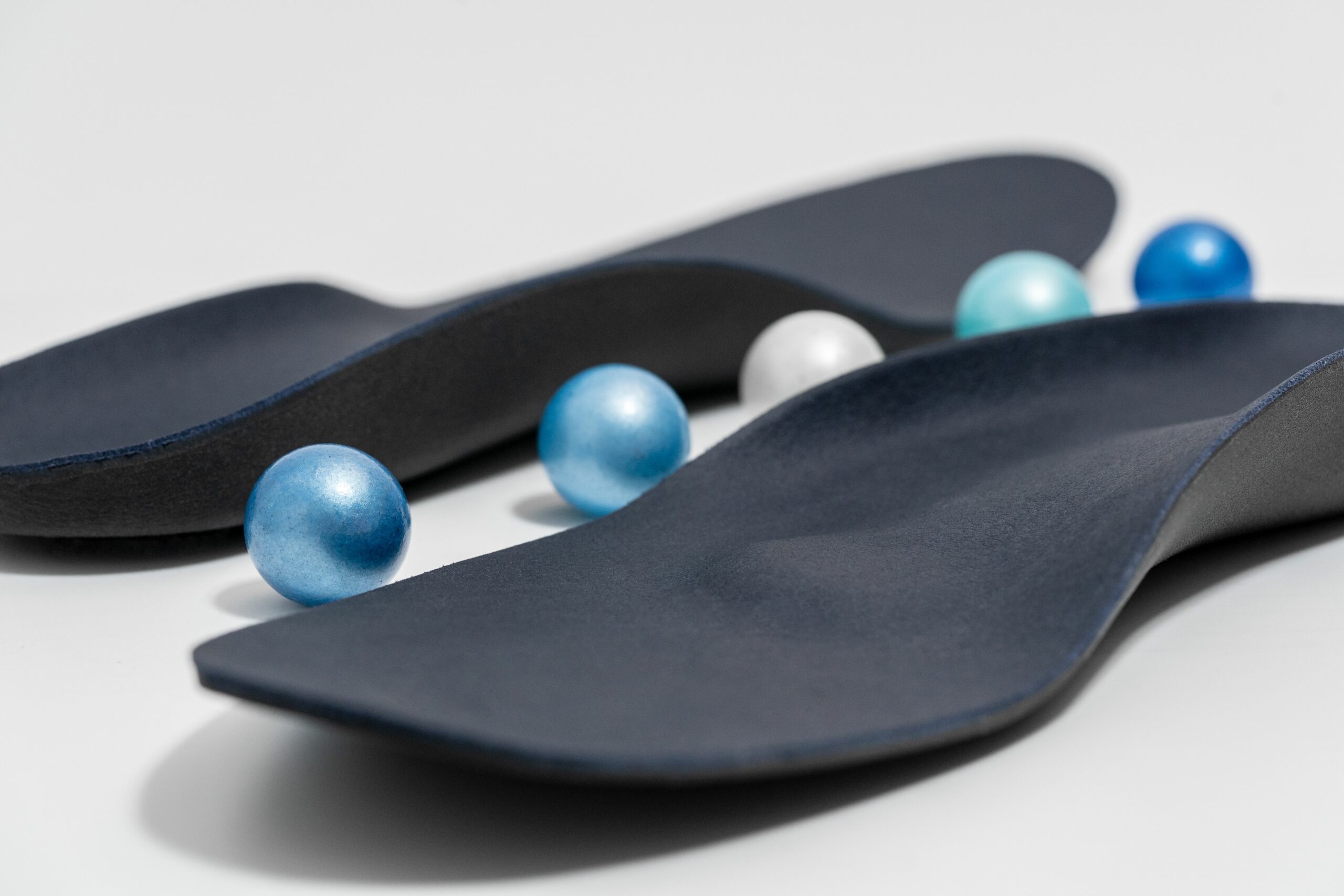 pair of insoles arranged with blue mables