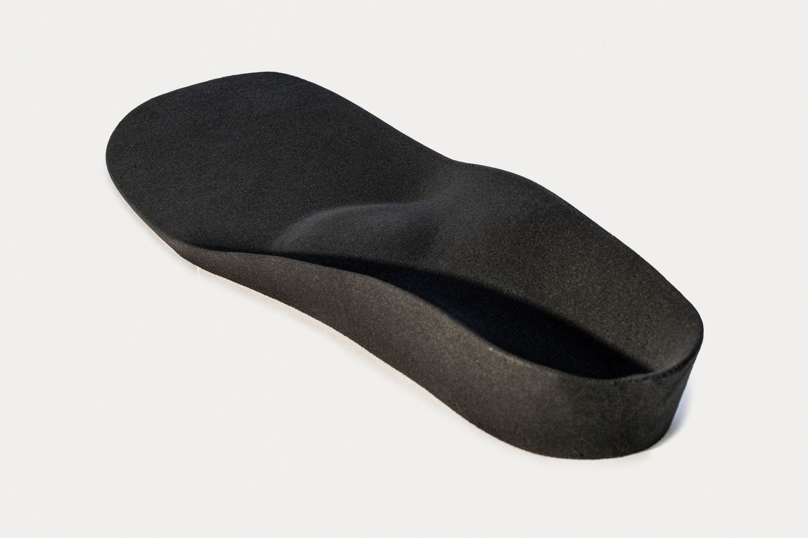 printed insole from top angle showing its shape with heightening and deepening