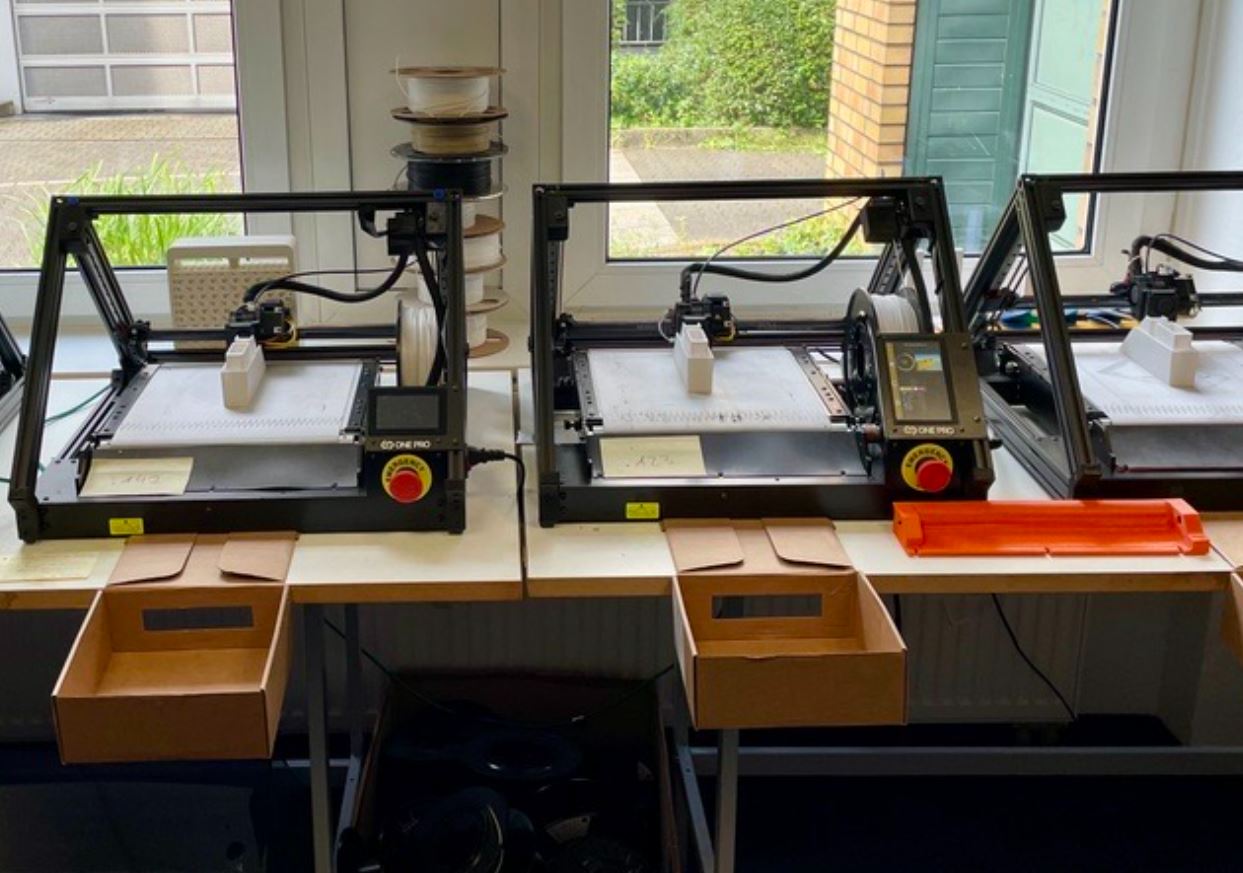 Mehrere One Pro 3D-Fließbanddrucker nebeneinander bei der simultanen Serienproduktion